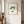 Meadow Muse art in a red oak frame hung in an entryway