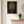 Midnight Garden Lady art in a red oak frame styled in an entryway