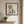 Mimosa Morning botanical garden scene wall art print in a black frame hanging in an entryway