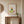 Nature at Play print in a red oak wood frame hanging in an entryway