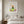Nature at Play print in a white frame hanging in a bedroom