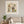 Petal Arch Wedding botanical wedding scene wall art print in a white frame hanging in a living room