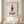 Petal Handstand botanical handstand wall art print in a red oak wood frame hanging in a bathroom