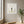 Petals in Balance art in a white frame styled in a yoga studio