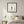 Petals in Balance art in a black frame styled in a bedroom