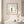 Petals in Balance art in a red oak frame styled in a bathroom
