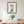 Plant Harmony art in a black frame hanging in a dining room