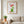 Plant Harmony art in a red oak frame hanging in a living room