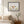 Poised in Nature art in a black frame styled in a bedroom