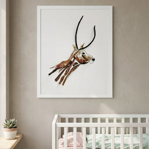 Quiet Gazelle in a white frame hung above a crib in a nursery