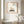 Quiet Wing Companions art in a red oak wood frame in a bathroom