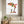 Reaching for Autumn art in a white frame in a serene living room