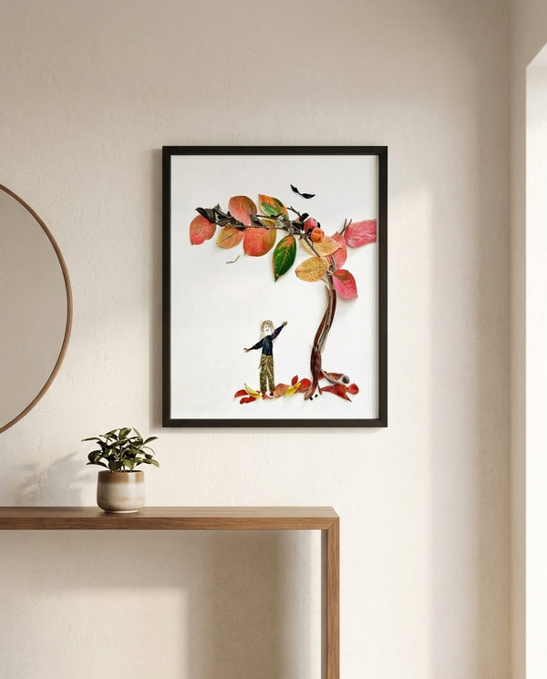 Reaching for Autumn art in a black frame in an entryway