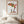 Reaching for Autumn art in a red oak wood frame in a bedroom