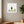 Rooted Tree Pose art in a white frame hung in a serene yoga studio