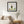 Rooted Tree Pose art in a black frame hung in a bedroom