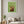 Rosy Gathering botanical still life wall art print in a white frame hanging in a living room