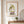 Soft Harvest Lady art in a red oak wood frame in an entryway
