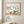 Squirrels Beneath the Leaves art in a red oak wood frame in a bathroom