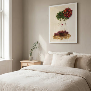 Strawberry Lady art in a white frame in a serene bedroom