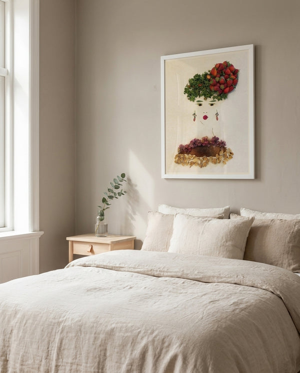 Strawberry Lady art in a white frame in a serene bedroom