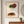 Strawberry Lady art in a red oak wood frame in an entryway