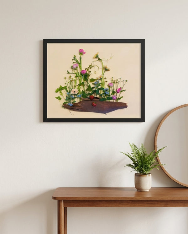 Strawberry Patch wildflower landscape wall art print in a black frame hanging in an entryway