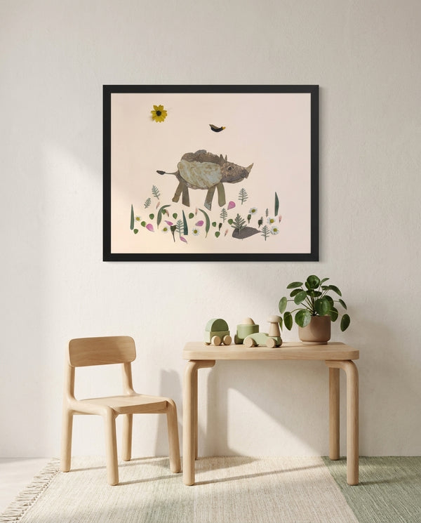 Little Rhino botanical baby rhino wall art print in a black frame hanging in a kids room