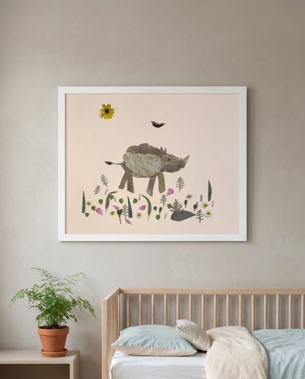 Little Rhino botanical baby rhino wall art print in a white frame hanging in a nursery