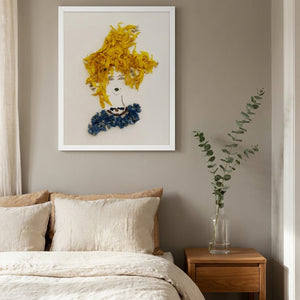 Sunflower Tresses floral feminine portrait wall art print in a white frame hanging in a bedroom