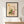Sunlit Windowsill botanical garden window wall art print in a black frame hanging in an entryway