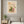 Sunlit Windowsill botanical garden window wall art print in a white frame hanging in a living room