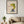 Whispering Spring botanical feminine profile wall art print in a black frame hanging in a living room