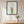 Wild Stem Vessel in a black frame hung in a dining room