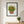 Woodland Flower Basket botanical still life wall art print in a black frame hanging in an entryway