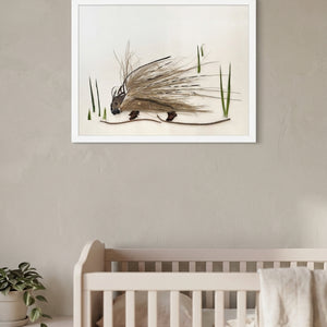 Woodland Porcupine art in a white frame hung in a nursery